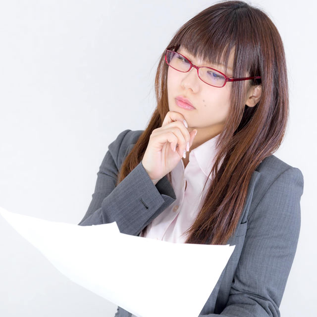 書類を見比べる女性